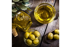 Image Olives and olive oil in glass bottle and bowl.